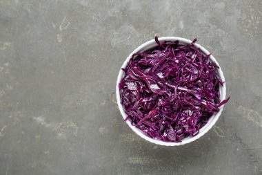 Tasty red cabbage sauerkraut on light grey table, top view. Space for text
