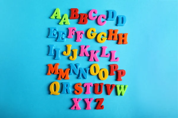 Many Colorful Magnetic Letters Light Blue Background Flat Lay Alphabetic — Fotografia de Stock