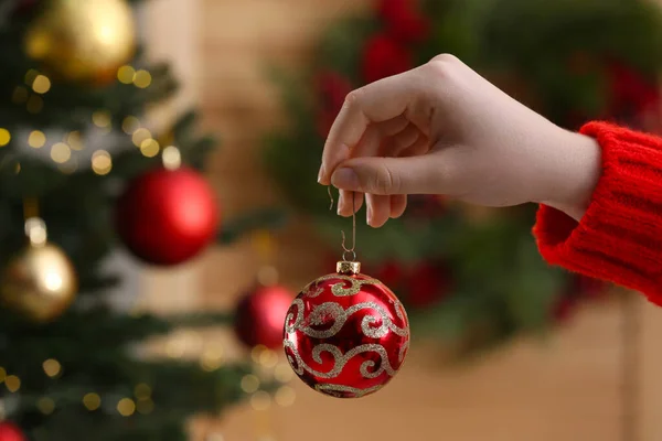 Woman Holding Red Ball Christmas Tree Indoors Closeup — Fotografia de Stock