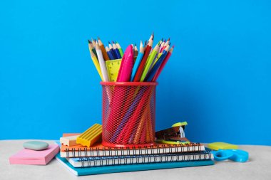 Different school stationery on table against light blue background. Back to school