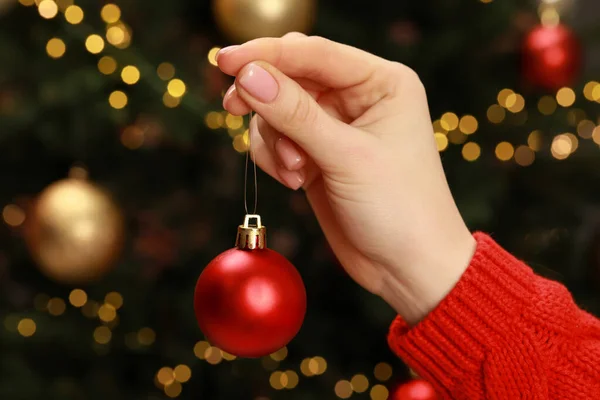 Woman Holding Christmas Ball Blurred Lights Closeup — Fotografia de Stock