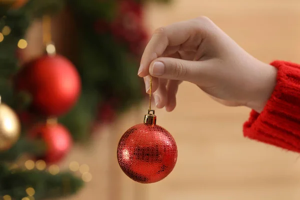 Woman Holding Red Ball Christmas Tree Indoors Closeup — Fotografia de Stock