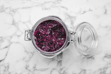 Tasty red cabbage sauerkraut on white marble table, top view