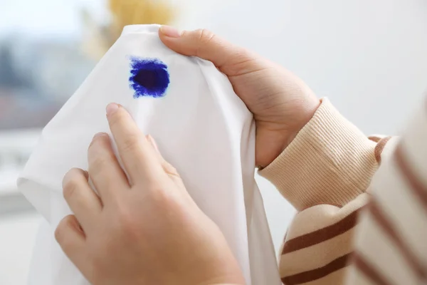 Woman Holding White Shirt Blue Ink Stain Blurred Background Closeup — Fotografia de Stock