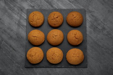 Delicious oatmeal cookies on grey table, top view