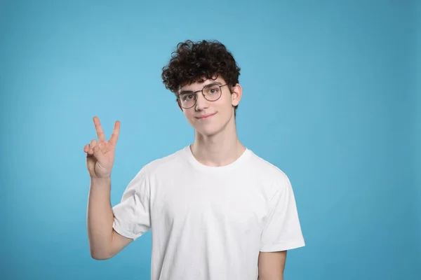 Portrait Cute Teenage Boy Wearing Glasses Showing Peace Gesture Light — 스톡 사진