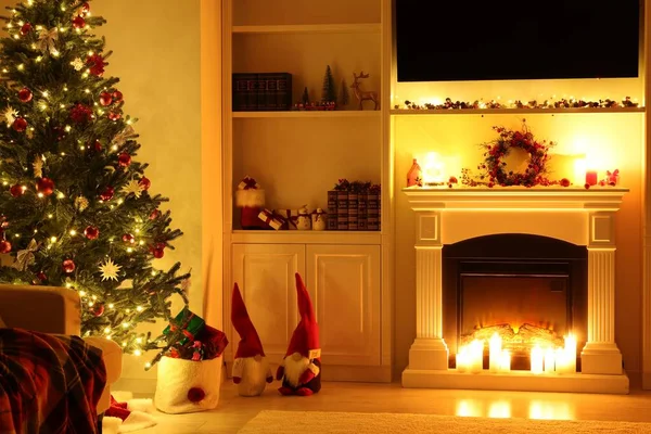 Cosy room with fireplace and burning candles. Christmas atmosphere