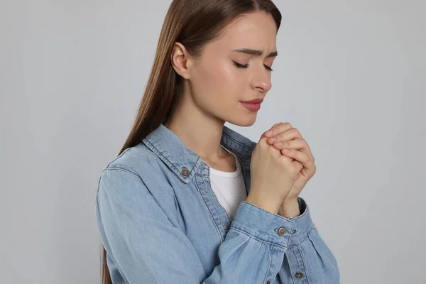 Woman Clasped Hands Praying Light Grey Background — Stockfoto