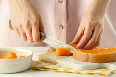 Woman cutting boiled pumpkin at table, closeup. Child's food