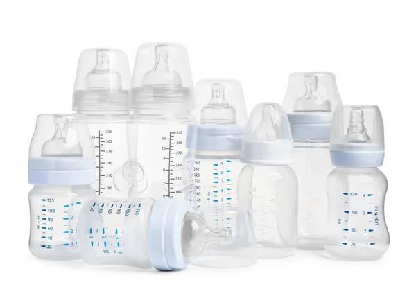 Many different empty feeding bottles for infant formula on white background