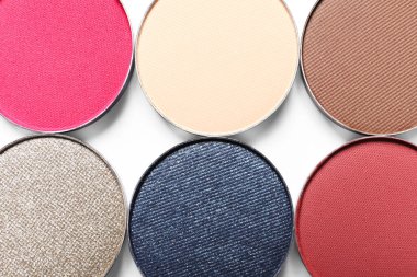 Different beautiful eye shadows on white background, flat lay