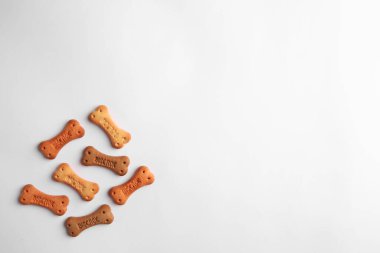 Bone shaped dog cookies on white background, top view. Space for text