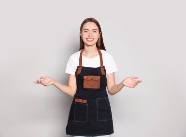 Portrait of happy hairdresser on light background