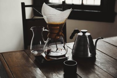 Dishware for coffee making on wooden table in cafe