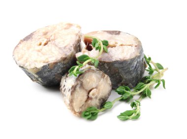Canned mackerel chunks with thyme on white background