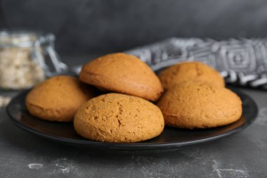 Delicious oatmeal cookies on grey table, closeup