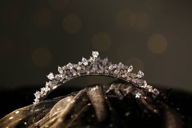 Beautiful silver tiara with diamonds on dark cloth
