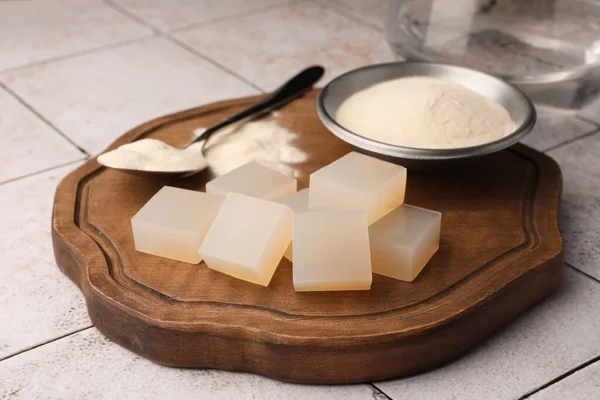 Agar-agar jelly cubes and powder on tiled surface
