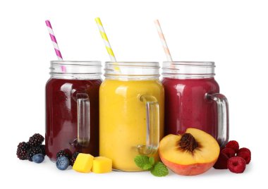 Different tasty smoothies in mason jars isolated on white