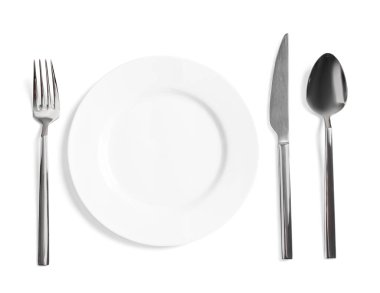 Clean plate and shiny cutlery on white background, top view