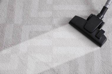 Vacuuming carpet. Clean area after using device, closeup
