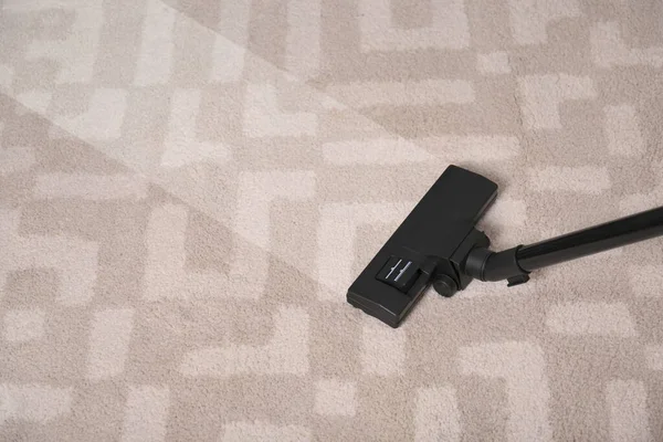 Vacuuming dirty carpet. Clean area after using device, closeup