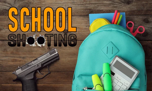 School shooting. Phrase with bullet holes, gun and backpack on wooden background, flat lay