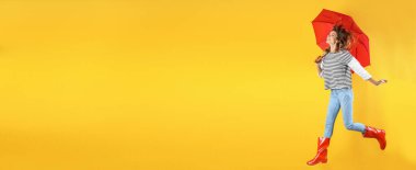 Autumn season. Happy woman with red umbrella on yellow background, space for text. Banner design