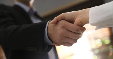 Business partners shaking hands after meeting in office, closeup. Banner design