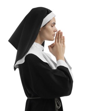 Nun with clasped hands praying to God on white background
