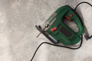 Green jigsaw on floor indoors, top view. Space for text