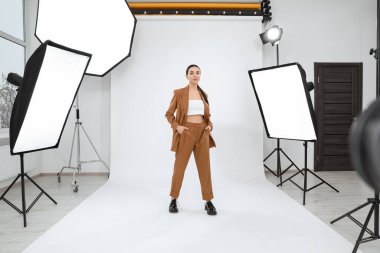 Beautiful young model posing in modern studio. Professional photo session