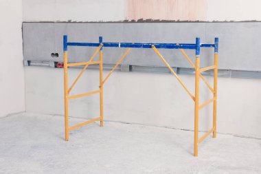 Tower tour near wall with adhesive mix and tiles indoors