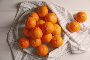 Many fresh ripe tangerines on white wooden table, flat lay