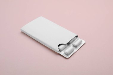 Blister with chewing gums on pink background