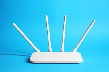 New white Wi-Fi router on blue background