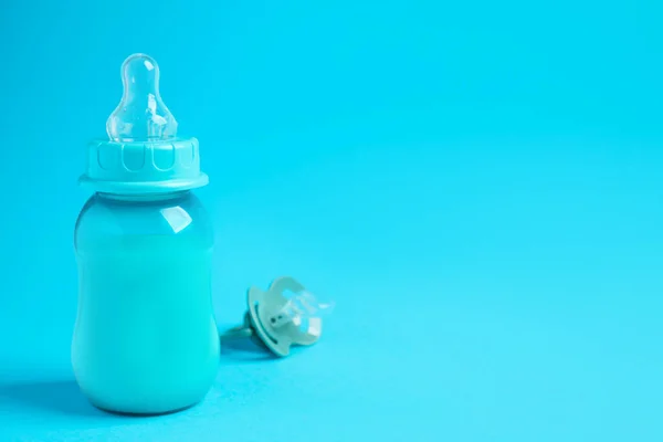 One Feeding Bottle Milk Pacifier Light Blue Background Space Text — Zdjęcie stockowe