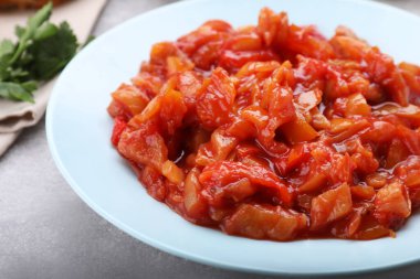 Delicious lecho on light gray table, closeup