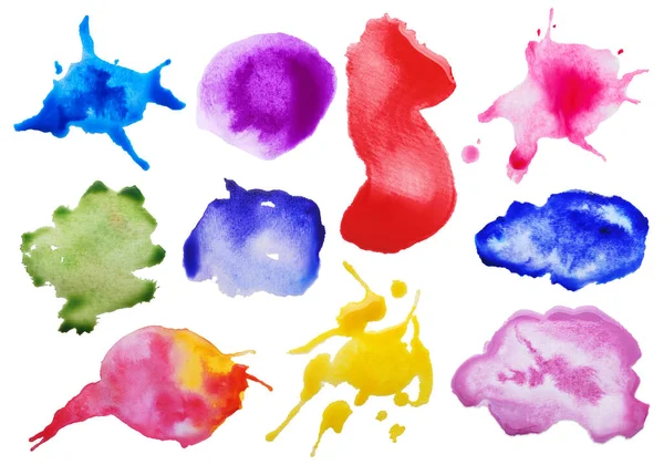 Set with colorful blots of ink on white background, top view