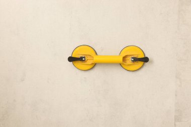 Vacuum holder on wall tile. Home improvement