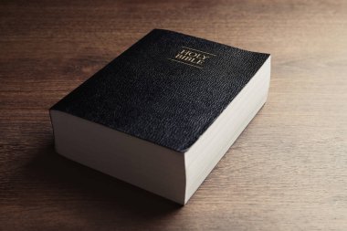 Holy Bible on wooden table, closeup. Religious book