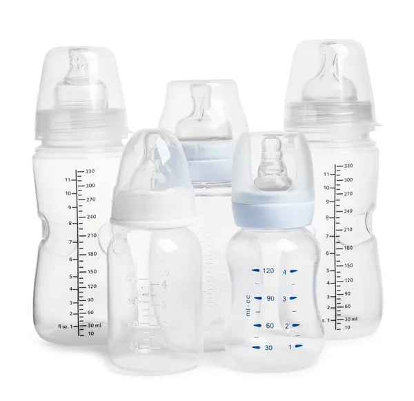 Many different empty feeding bottles for infant formula on white background