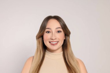 Dudağında piercing olan genç bir kadın.