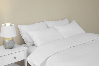 White soft pillows on cozy bed in room