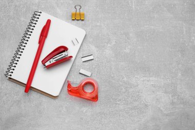 Flat lay composition with new stapler on grey table, space for text