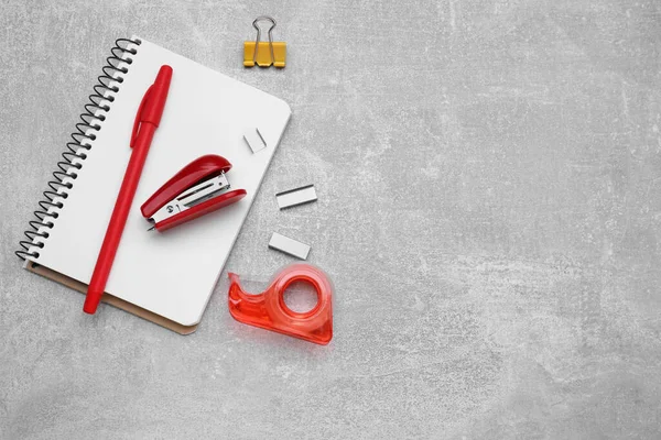 Flat lay composition with new stapler on grey table, space for text