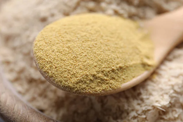 Beer yeast powder and flakes, closeup view. Effective remedy