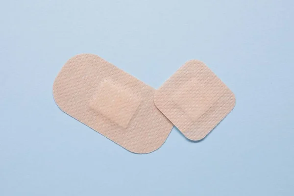 Contraceptive patches on light blue background, flat lay
