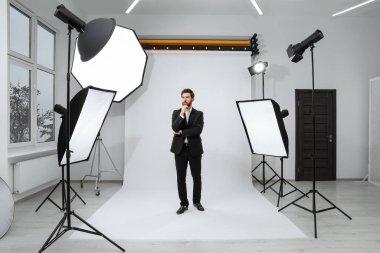 Handsome model posing in modern studio. Professional photo session