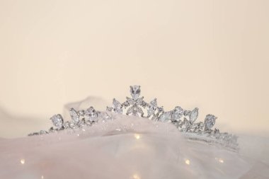 Beautiful silver tiara with diamonds on light cloth